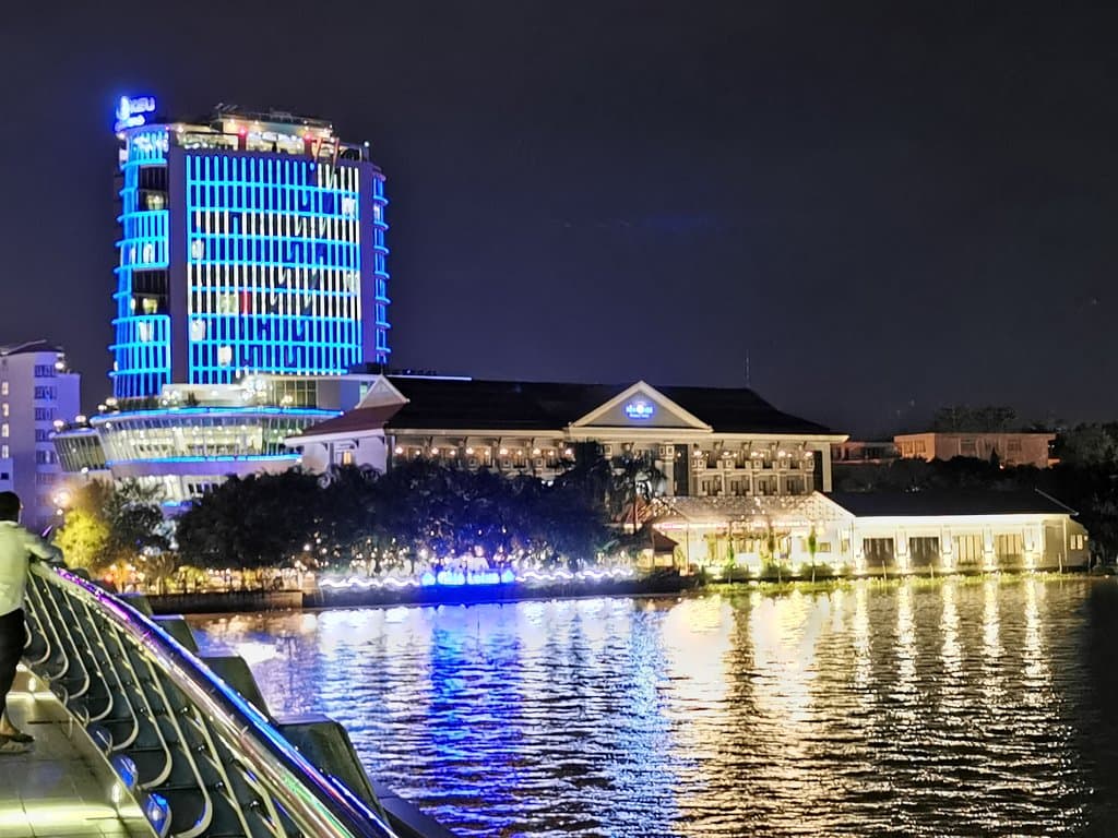 Ninh Kieu pedestrian bridge surroundings, lighted up at night.