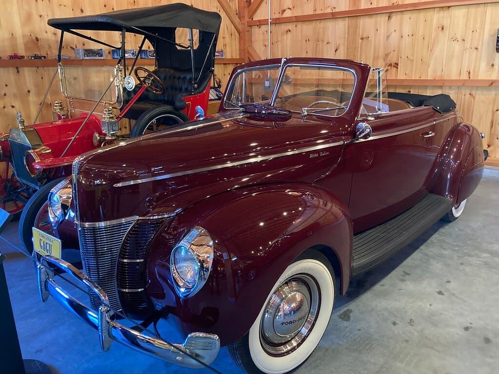 1940 Ford Convertible, Model T truck in the background.