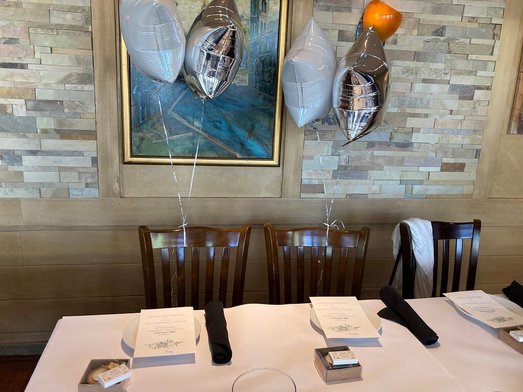 Table setting showing brickwork on wall at one side of room