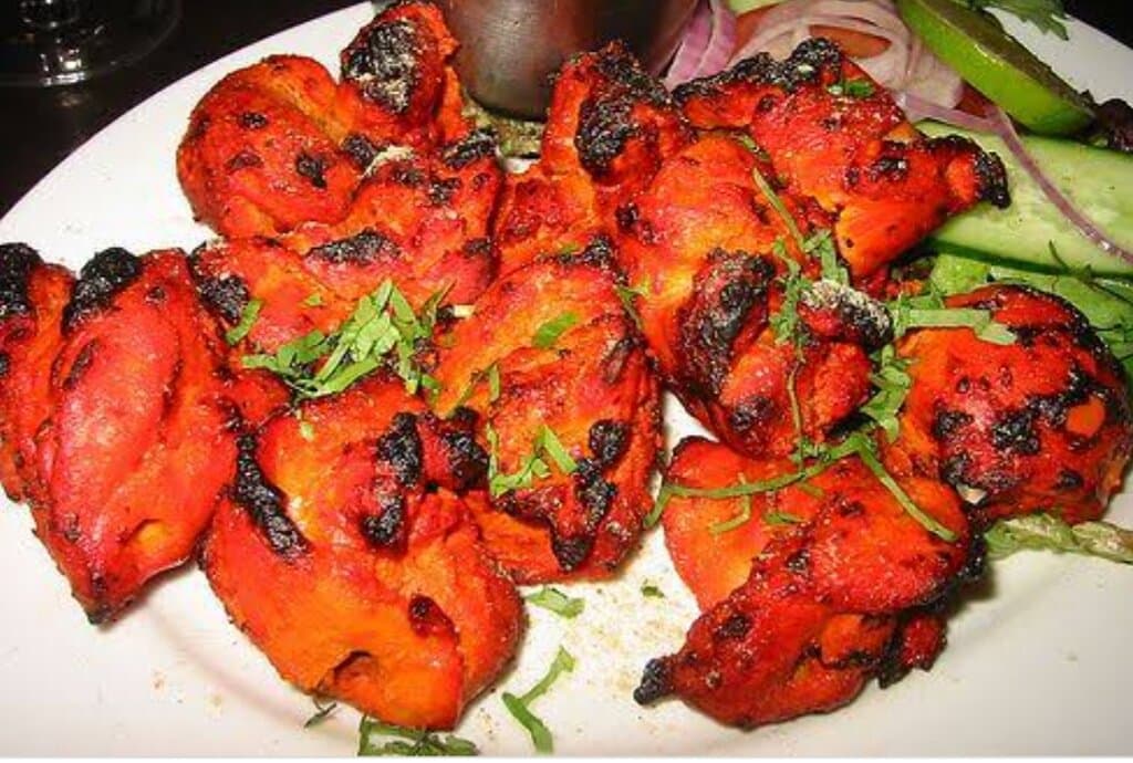 Tandoori chicken tikka boneless marinated with ginger,garlic,yogurt,mustard oil , lemon and home made indian spices cooked in tandoor served with mint sauce