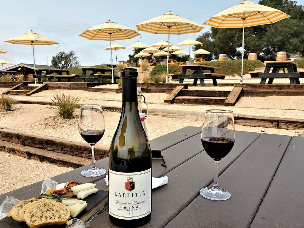 Cheese Platter and delicious Pinot too.  Bocce Ball Court in background.