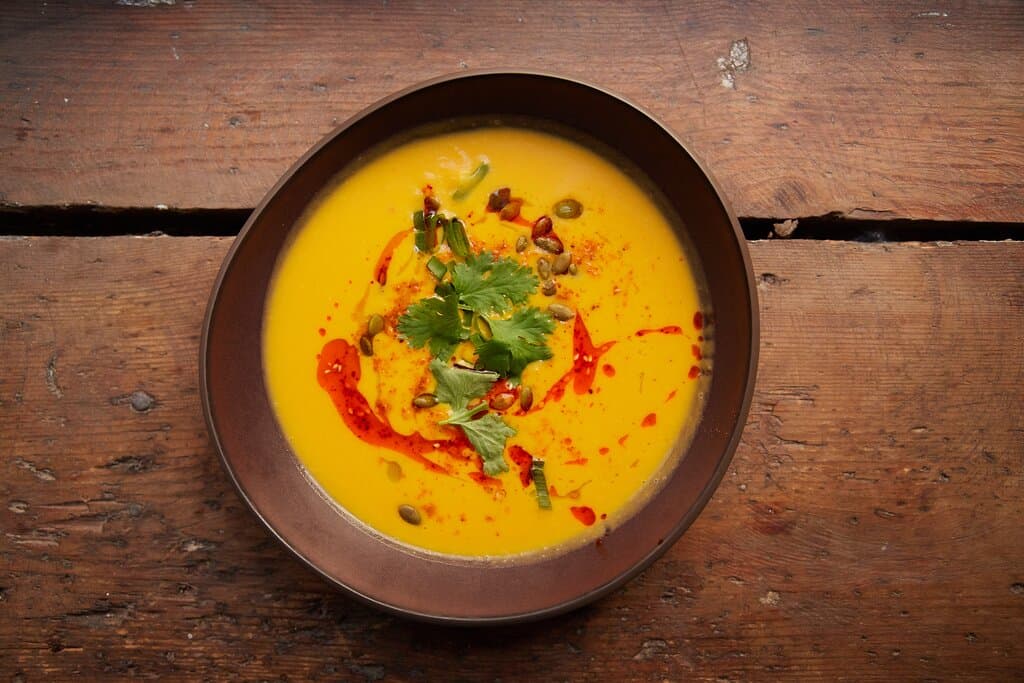 Creamy pumpkin-coconut-peanut butter purée soup with spicy Sichuan oil