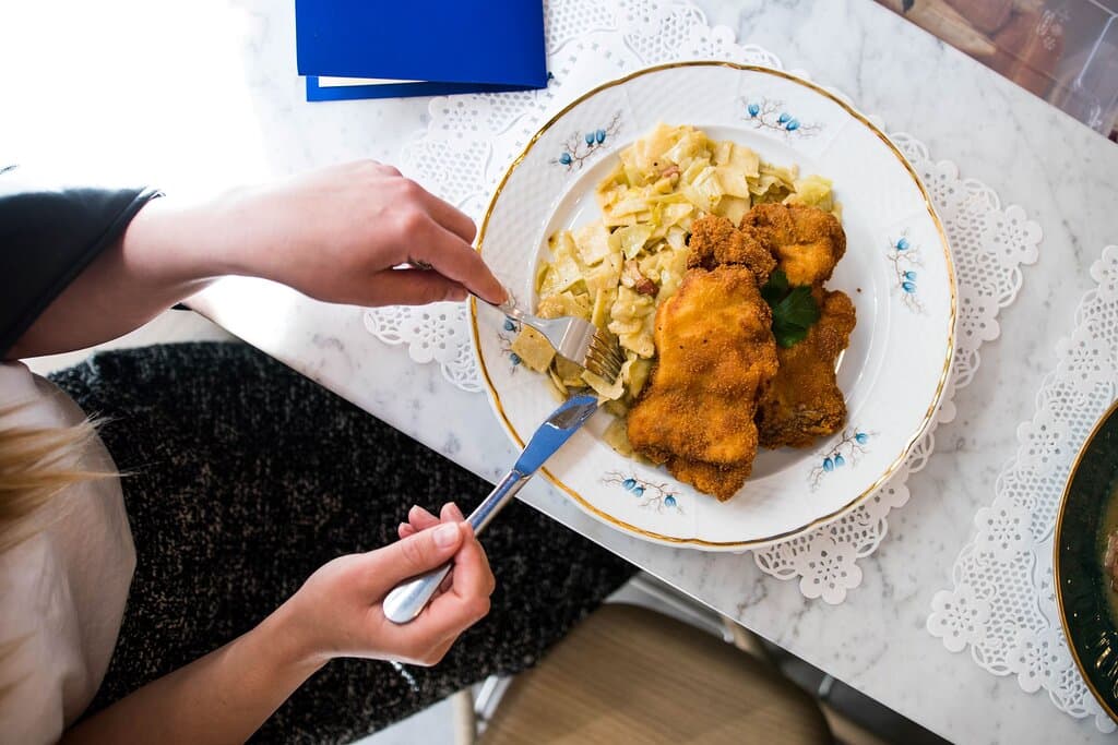 Fried chicken and handmade pasta with cabbage and bacon