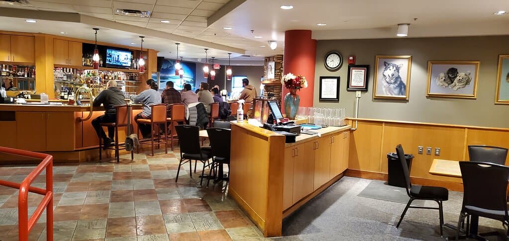 Tall round tables to the left, and tables, and booths down the middle (out of sight in middle of picture)  