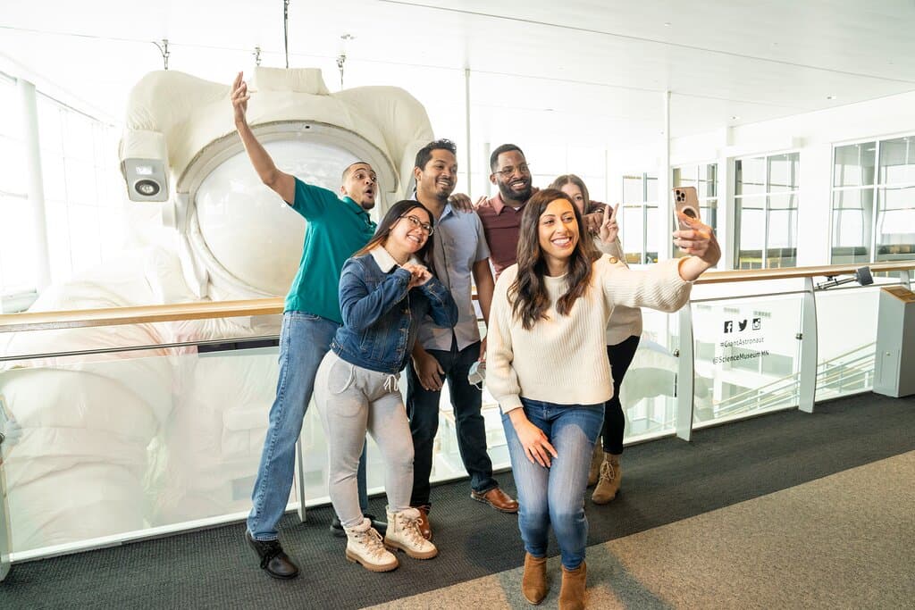 Visitors taking photos in front of the giant astronaut. 