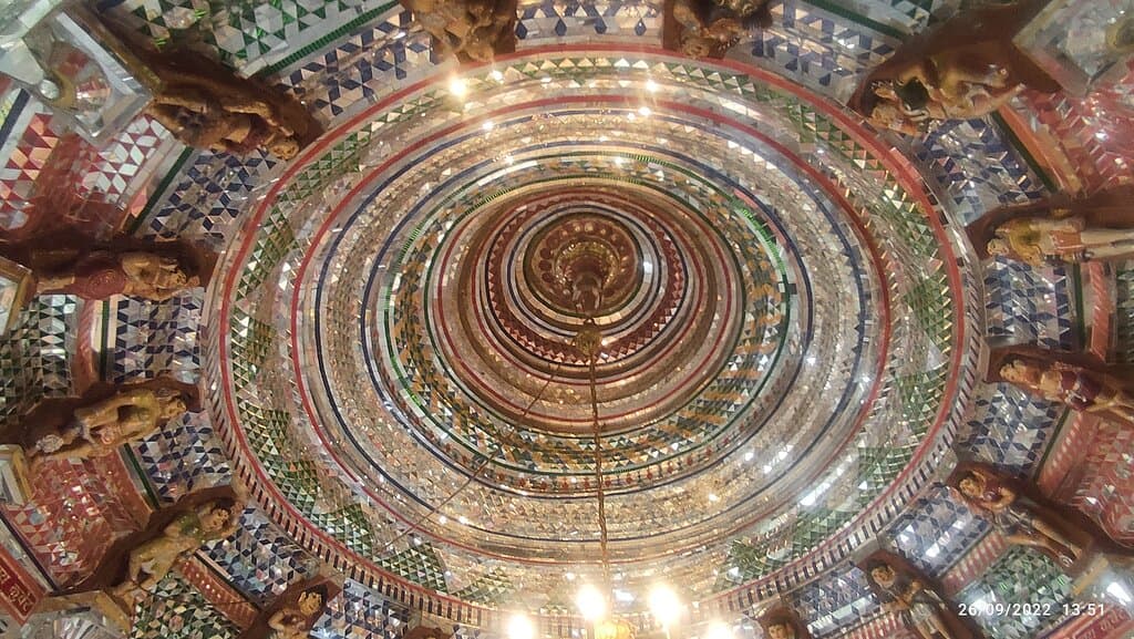 Multi-coloured geometrically cut glass and mirror pieces, interspersed with female statues make very beautiful dome of Kuber Temple. Karnali,