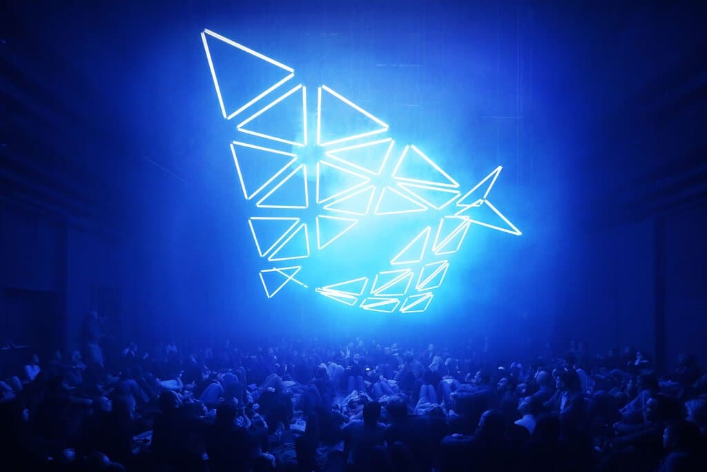 GRID combines kinetic motion, light and electronic music  to create a giant audiovisual sculpture that hovers above the audience. The audiovisual installation symbolizes the merging of the digital and physical world. GRID is enduring and fleeting at the same time.