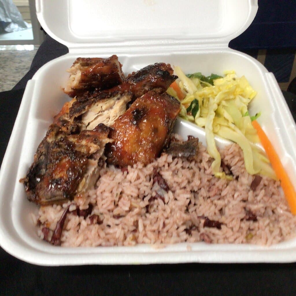 Jamaican jerk chicken with peas and rice and a cabbage salad