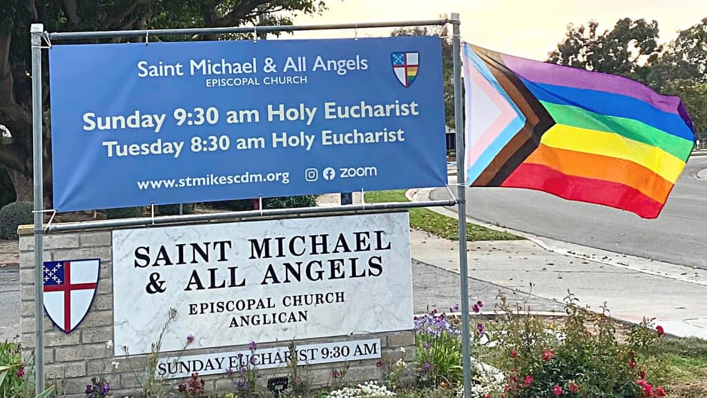 We post seasonal banners above our sign. Here we have the progressive Pride flag flying for Pride Month.