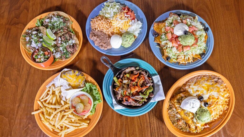 Street style tacos, supreme nachos, Mexican cheeseburger, beef fajitas with side plate, and a chimichanga. 