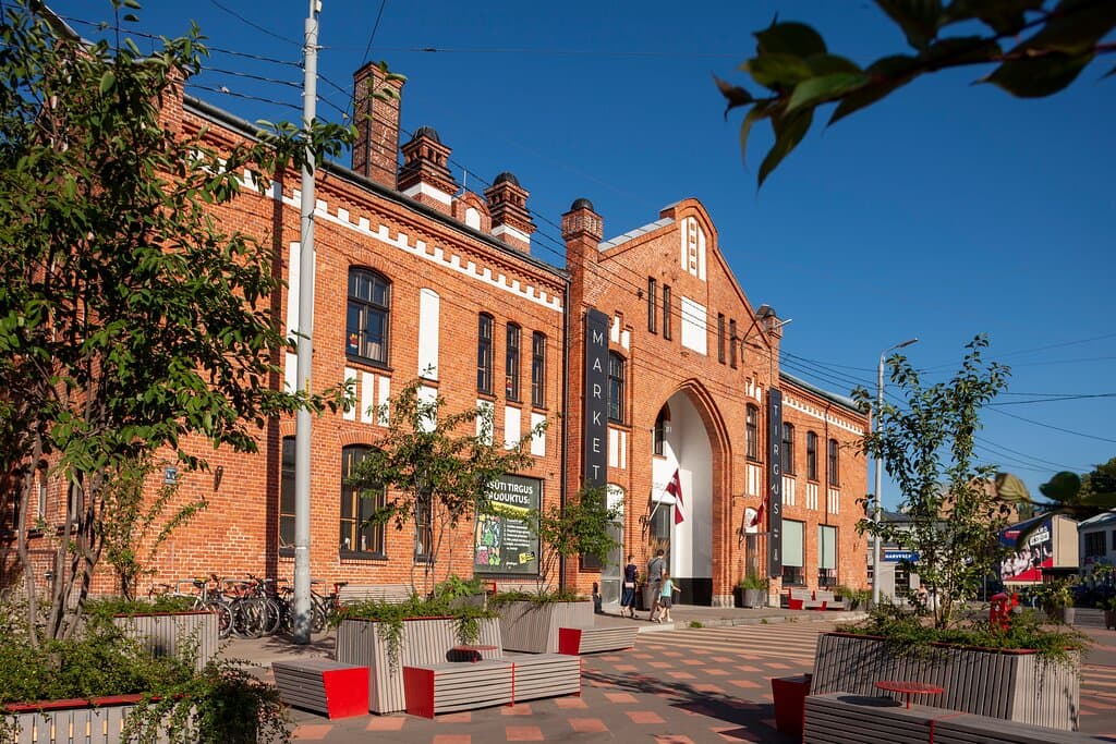 Built in 1893, the Āgenskalns market building by the architect is a unique example of the rational Art Nouveau style of the beginning of the 20th century with red brick exterior walls, decorative plastered areas, expressive vertical windows, and decorative chimneys.