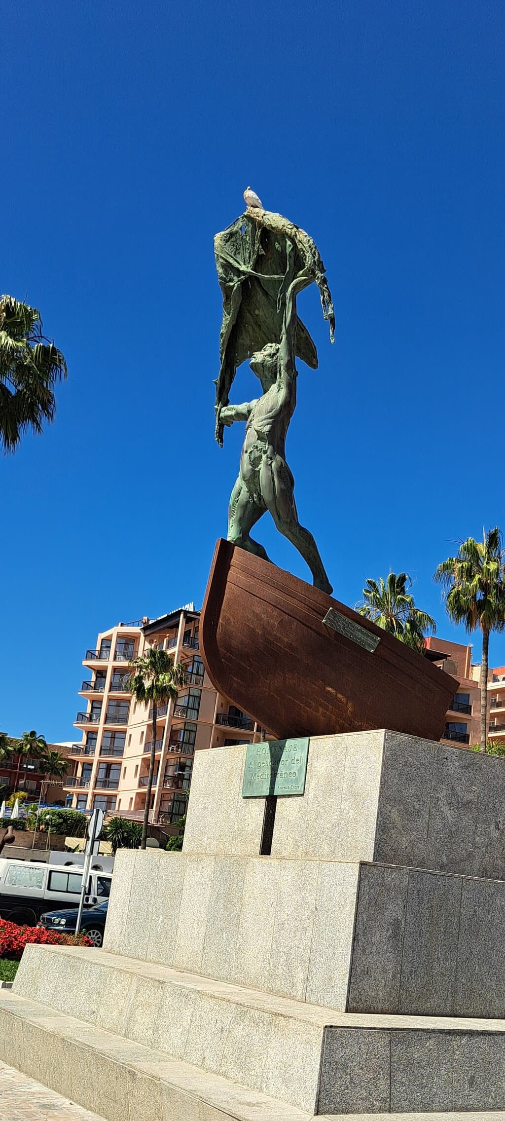 Fisherman holding something aloft 
