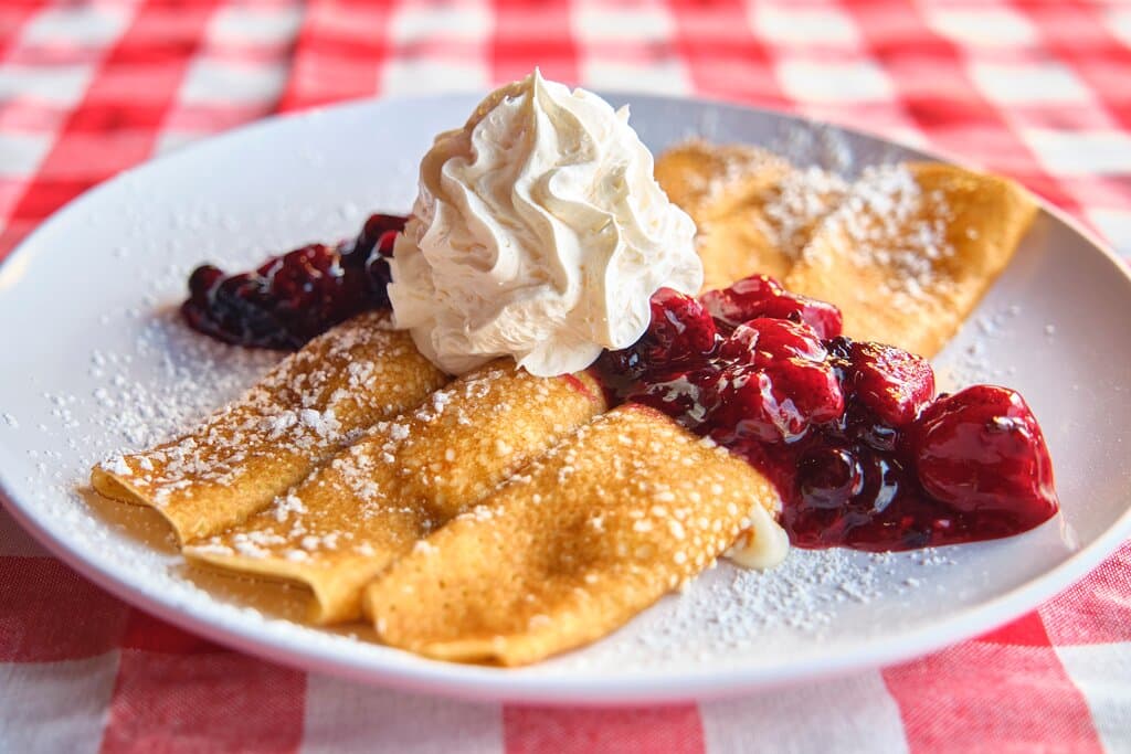 Our locally-owned and operated restaurant has quickly become a beloved institution, earning high praise on Trip Advisor and Yelp for our exceptional service and mouthwatering dishes. At Sawyer’s Farmhouse, we're committed to starting your day right. Our breakfast menu is packed with a variety of delights, including fluffy, made-from-scratch pancakes, luscious crepes. Each dish is served with our freshly-whipped butter and warm homemade syrups, lovingly prepared to complement your meal perfectly.