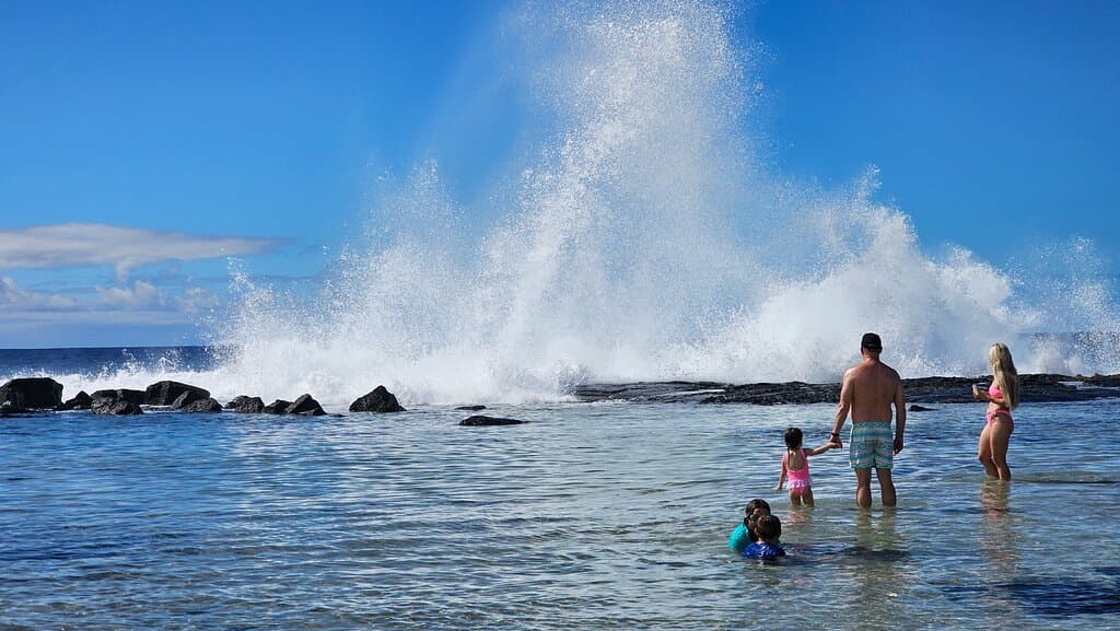 Waves hitting the rocks at Wawaloli Beach Park