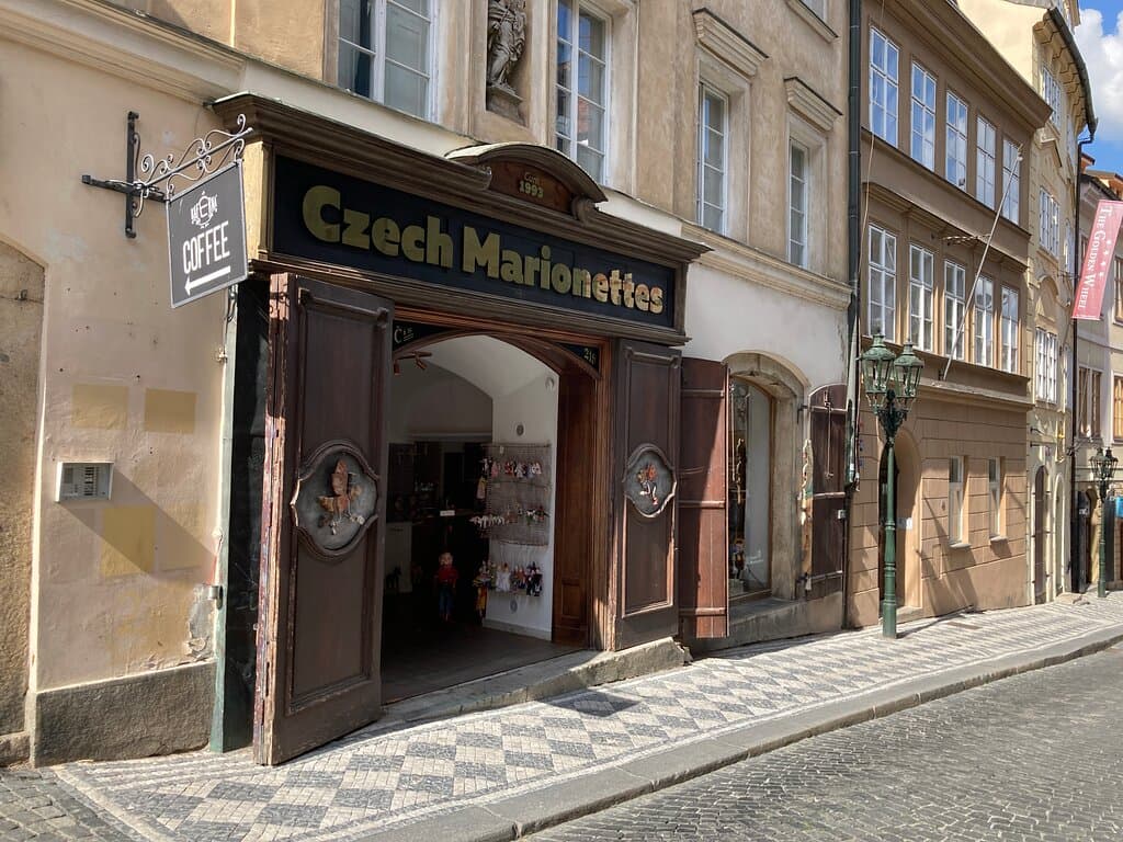 This is our store on Nerudova Street. Feel free to take a look and take as many photos as you desire. You can try some of our performance marionettes as well.