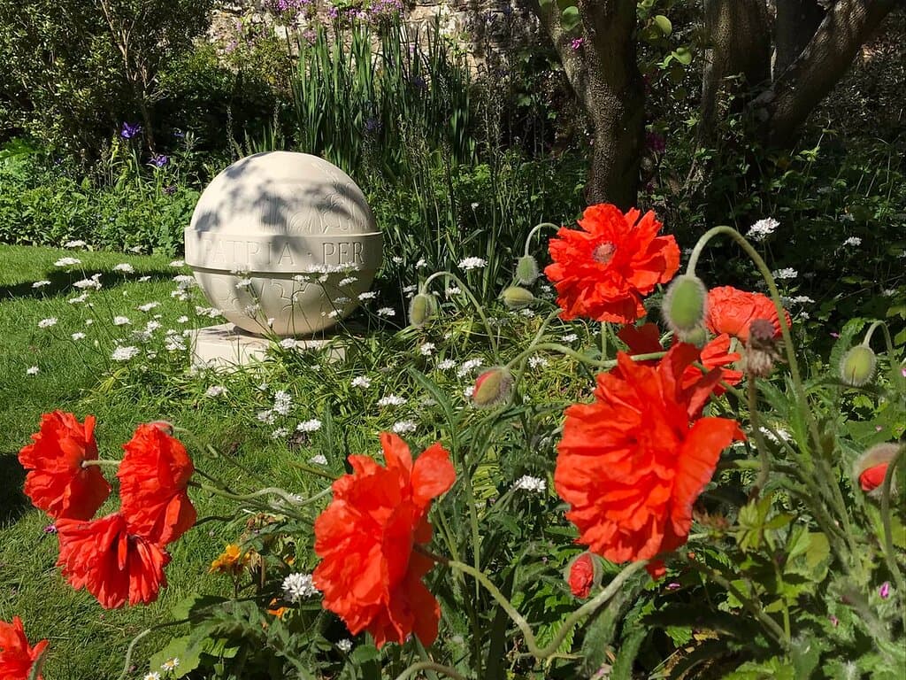 The Almonry Garden and inscribed stone orb 'Per Bellum Patria’ - through war a nation
