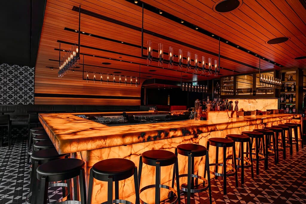 Our u-shaped backlit onyx bar is the perfect place to elevate your evening with hand crafted cocktails and Spanish-inspired small plates.