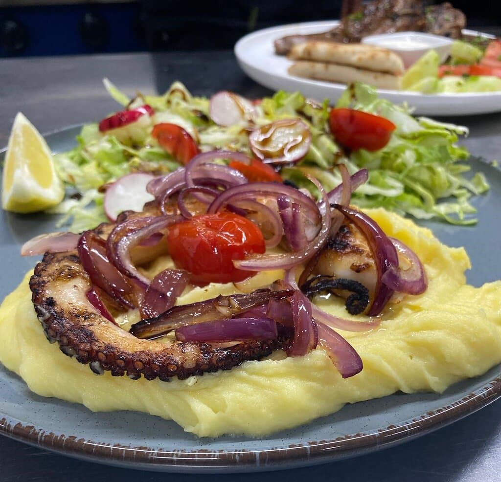 🔥 Experience the true taste of Greece at our restaurant! 🇬🇷 Savor our Char grilled tender octopus 🐙, drizzled with premium olive oil and Aegean herbs, served with a fresh leafy salad 🥗 and creamy mashed potatoes 🥔. We use only the freshest, highest-quality ingredients to bring you an unforgettable, delicious meal. 😋 #FreshIngredients #TasteOfGreece #GrilledOctopus #SeafoodLovers #AegeanFlavors #GourmetExperience #GreekCuisine #DeliciousFood #FoodiesDelight