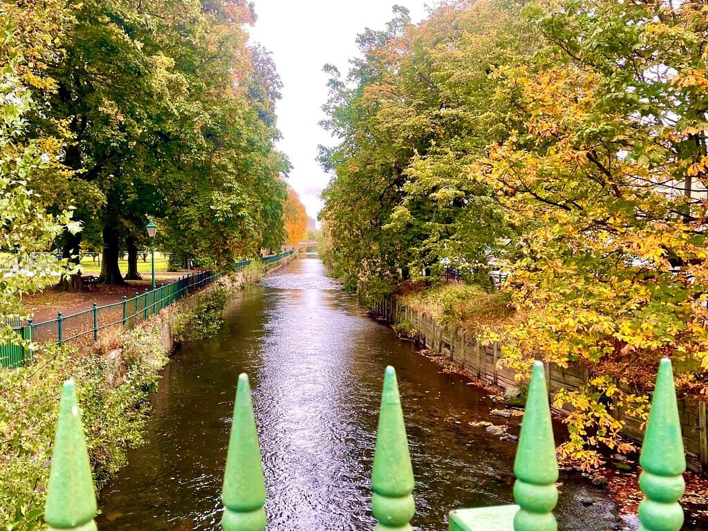 The river Eden flows through the tree-lined park, and apparently otters have been spied in the river. The  green - railed Victoria Bridge , which crosses over the water, was opened in 1901.