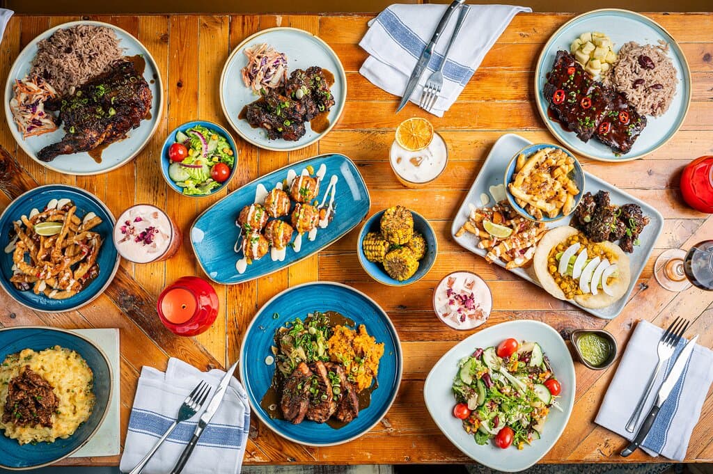 Serving up fresh Caribbean-inspired flavours, 2-4-1 cocktails at Happy Hour and our famous Bottomless Brunch. Relax and enjoy warming curries, our iconic smoky jerk pit, vibrant small plates and Reggae Roasts on Sundays. Our iconic mix of rum, reggae and jerk is perfect way to escape somewhere tropical for a while. 