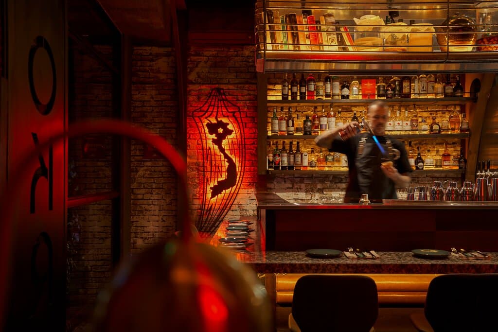 Immerse yourself in a blend of modern design and culinary artistry. The open kitchen showcases our commitment to transparency and innovation, where Chef Jamie Celaya and his team passionately craft globally inspired dishes. The warm lighting and stylish decor create an inviting atmosphere perfect for gathering with friends and family. Enjoy a dining experience that highlights bold flavors and a diverse menu, all while surrounded by the vibrant energy of our community.