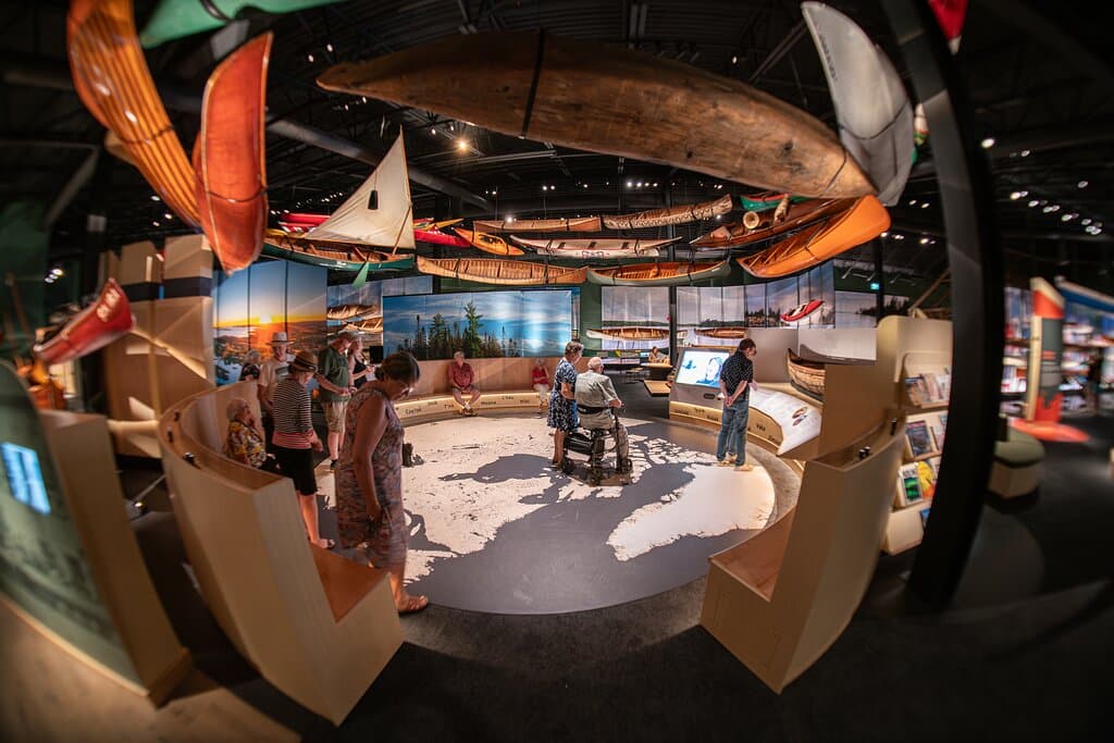 The Headwaters exhibit and Canoe Swirl with visitors taking it all in.