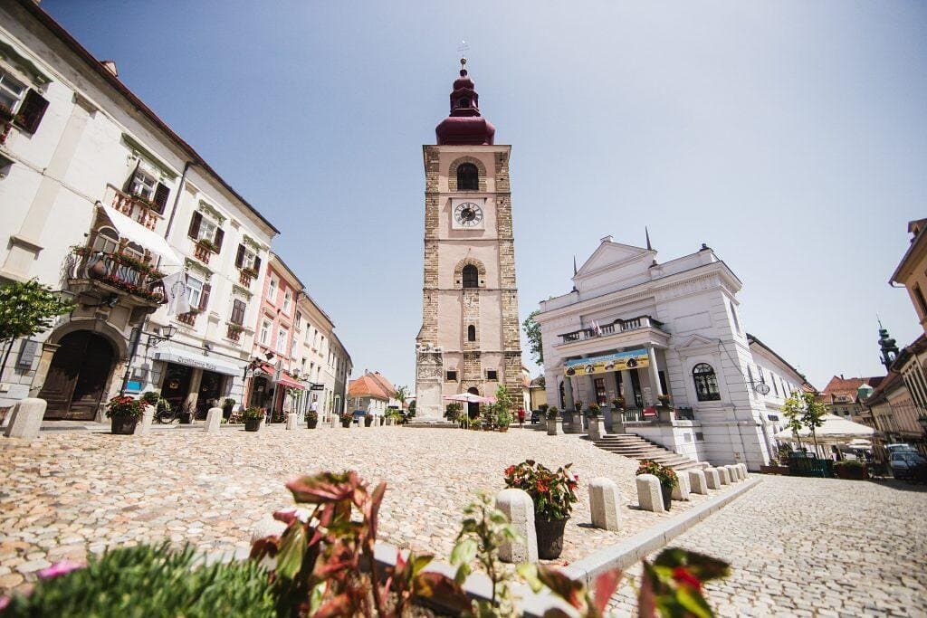 The City Tower and the bell tower of St. George’s Church is a striking element of Ptuj’s skyline, reaching an impressive height of 54 meters with its onion-shaped roof. In the form we largely recognize today, it was built in 1603 on the foundations of an older Gothic tower dating back to the 10th century. Initially, its function was defensive and observational, but as the need for timekeeping grew, the city tower gained the additional function of a bell tower with its mechanical clock...