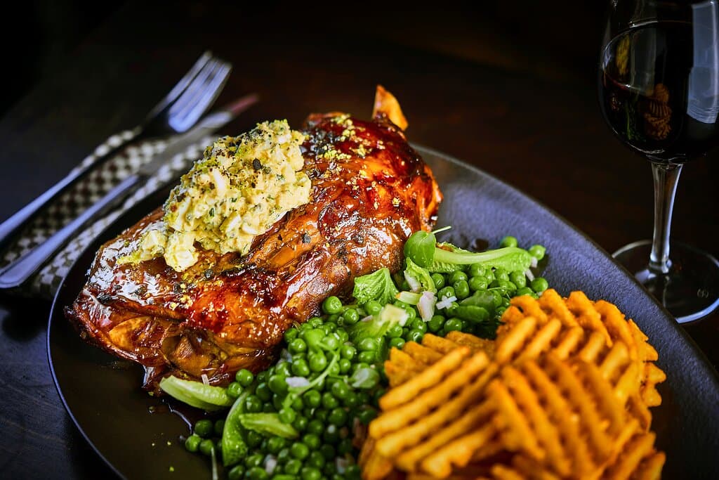 SLOW COOKED LAMB SHOULDERfor 12 hours, green peas, estragon sauce, waffle fries