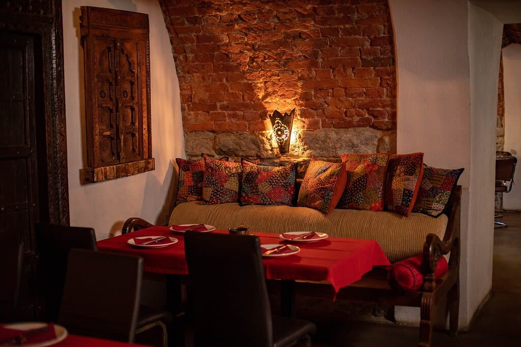 A cozy and romantic dining experience in a charming interior 🏰✨. Warm, inviting atmosphere with rustic tables and comfortable seating—perfect for a relaxed meal or a special night out. ❤️🍽️”