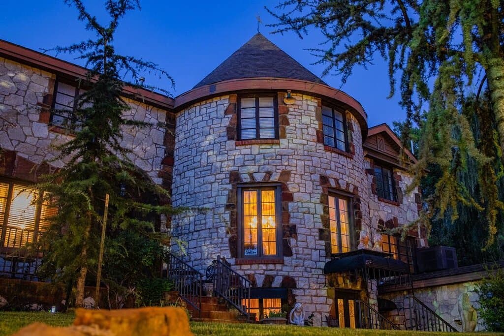 Castle Falls, the stunning dream home built by WWI veteran Bill Blecha, is beautifully illuminated in this night shot. Its stone facade, a detailed replica of a Normandy castle, truly makes it a unique setting for the Castle Falls Restaurant.  Ready to experience it for yourself? We're open for dinner on Thursday, Friday, and Saturday.