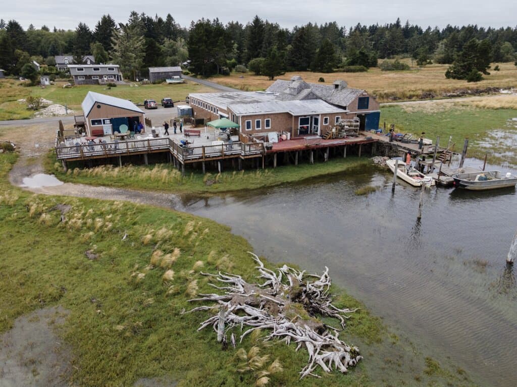 Expansive waterfront deck at Oysterville Sea Farms overlooking Willapa Bay. Enjoy fresh oysters, clam chowder, and local seafood with panoramic views in historic Oysterville, Washington. A must-visit destination for Pacific Northwest coastal charm and farm-to-table dining.