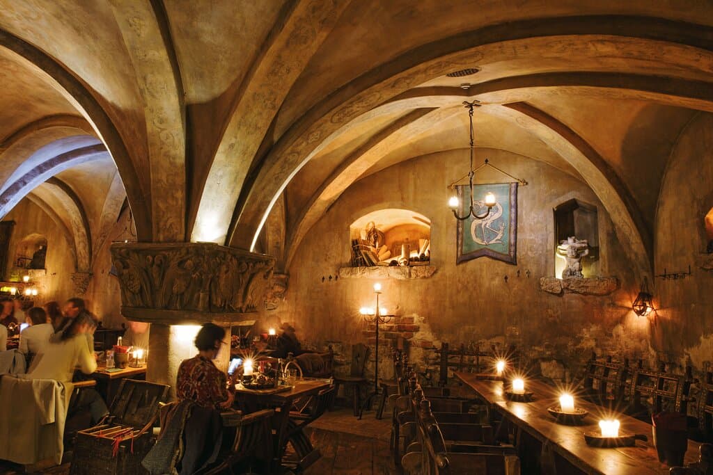 The restaurant ROZENGRĀLS is located in the centre of Old Riga on the Rozena Street. These premises were mentioned in the scripts in 1293 as the most ancient wine-vault and festival place of the Riga City Council!  In the largest room of the restaurant with a 4-meter high arches is still the only well in Riga and medieval fragment of the first defensive wall, built in 1201!  In 5 halls, in a medieval atmosphere at the same time we will be able to regale 150 guests with exquisite dishes prepared 