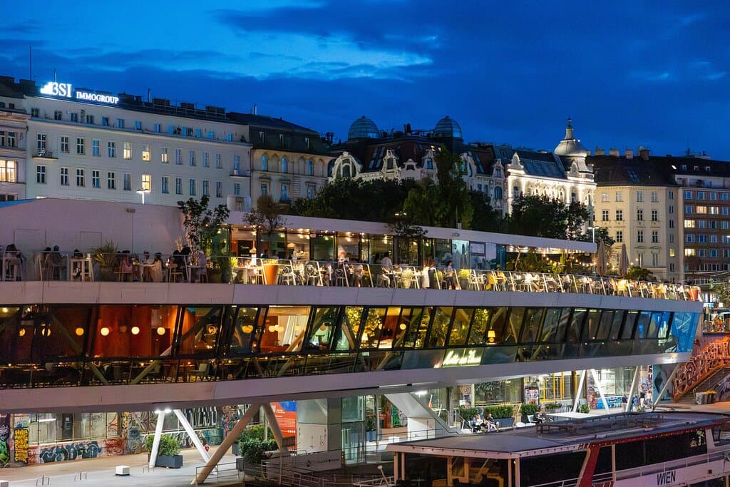 Stylisches Café direkt am Donaukanal in Wien mit großer Sonnenterrasse und Blick über’s Wasser. Genieße frisch gebackene Patisserie, hausgemachte Säfte, Kaffee und leichte Bistro-Gerichte in entspannter, urbaner Atmosphäre. Ideal für Frühstück, Brunch oder eine Auszeit am Fluss mit regionalen, saisonalen Zutaten und lässigem DJ-Sound an warmen Tagen.