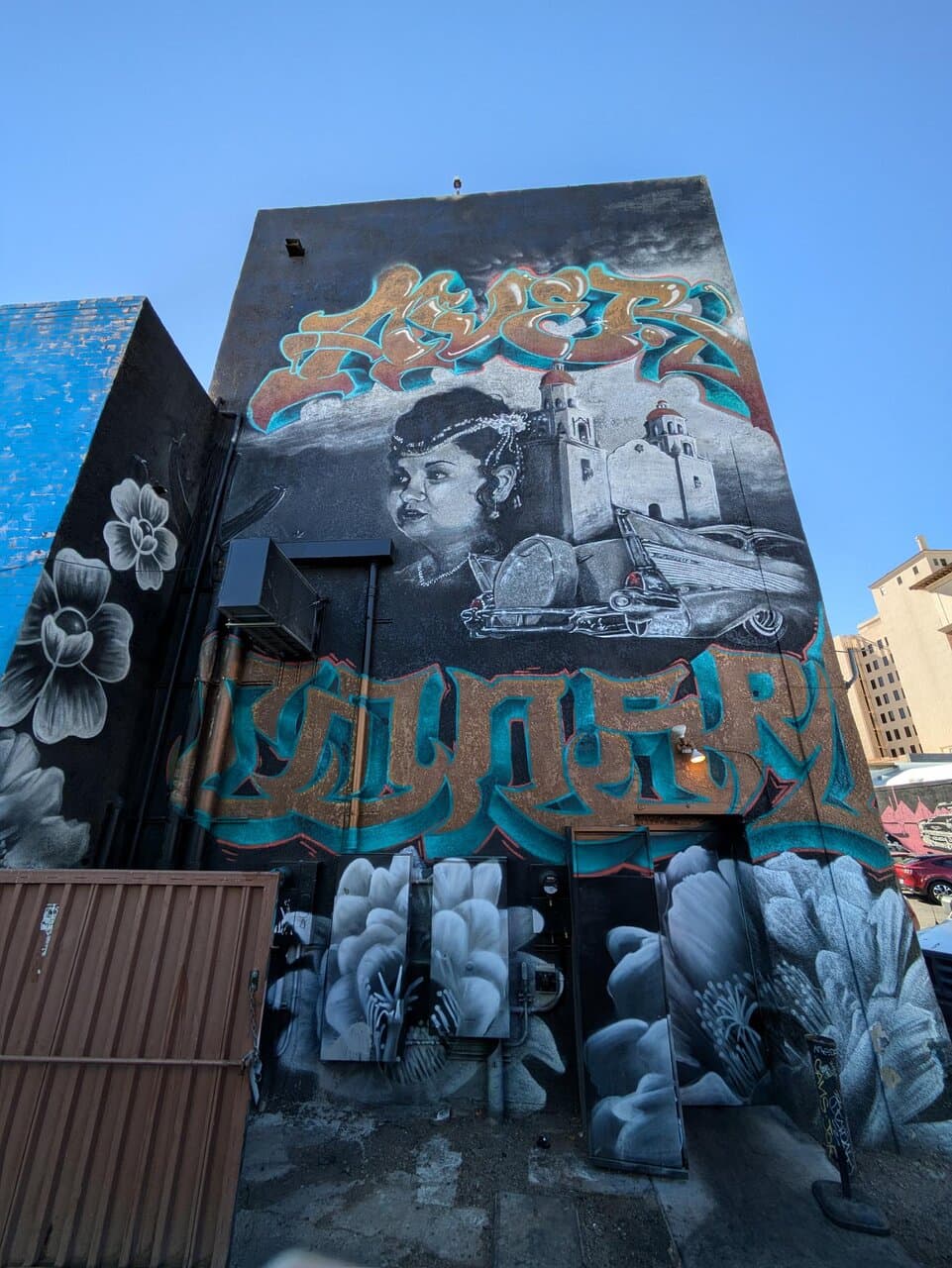 Mural at west end of alley leading from Scott Avenue (which is another route, lined with murals, to enter the parking lot).