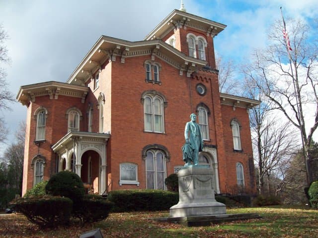 Front of the Fenton Mansion with a statue of former Governor Reuben Fenton