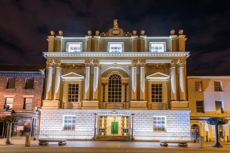 Mansion house façade at night.