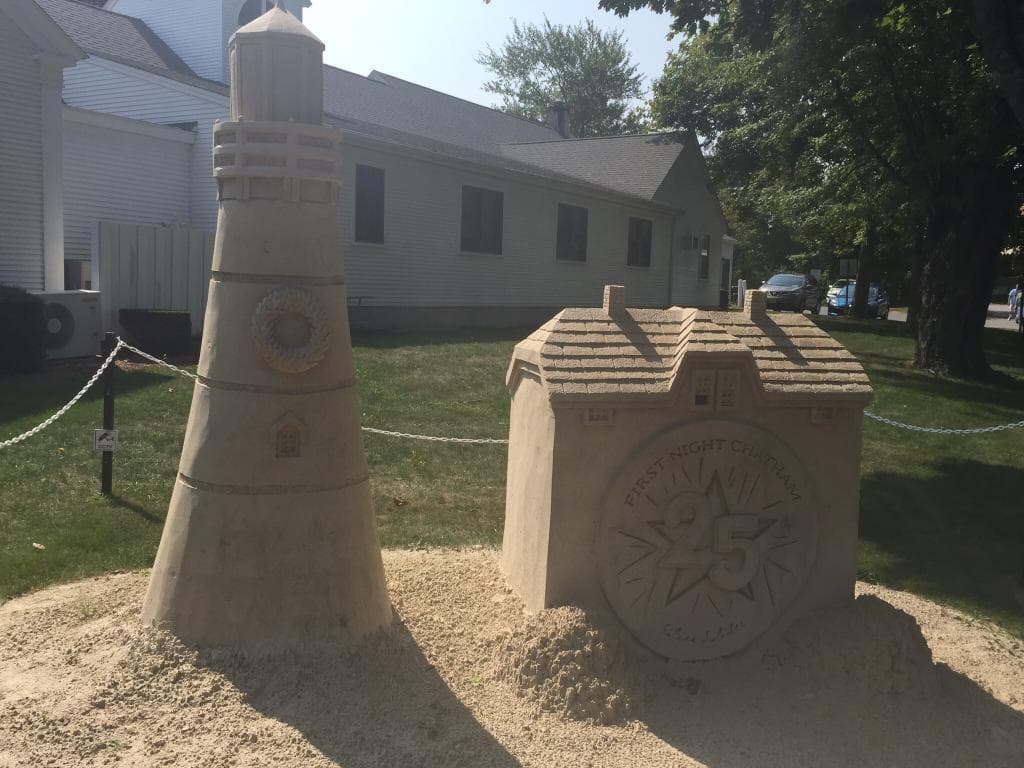 A sand sculpture of a lighthouse