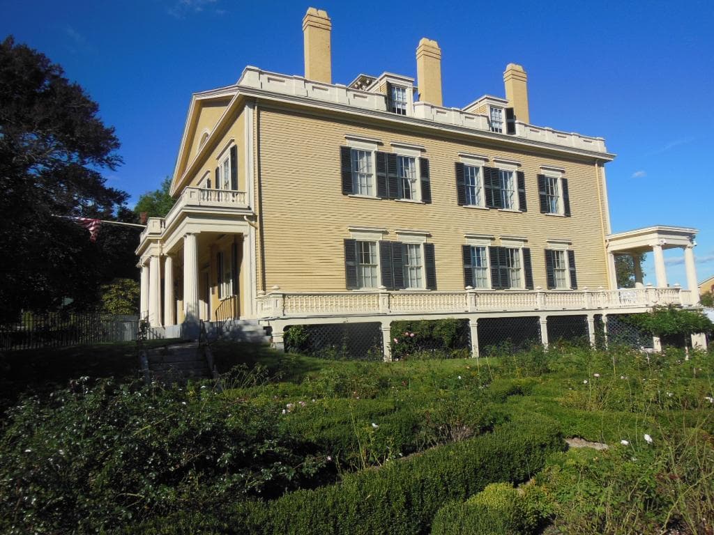 A side view of the enormous house taken from the formal gardens