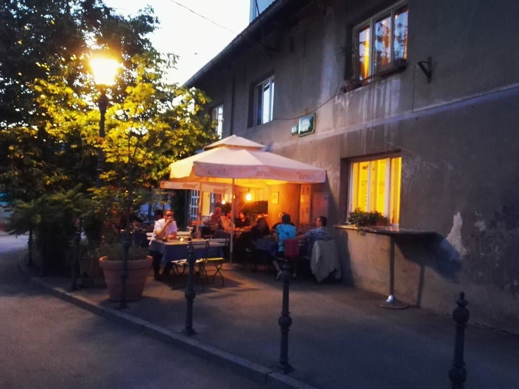 The street is a bit grotty, but a tree and selection of planters hide this