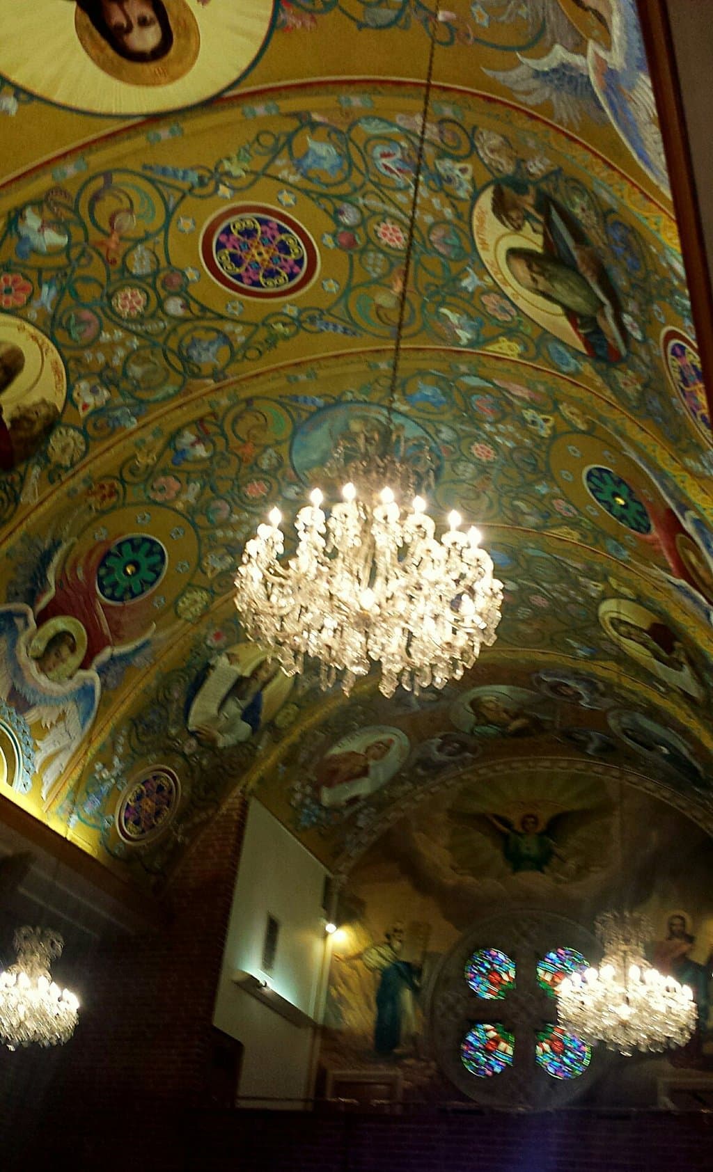 Ornate ceilings, chandeliers, and stained glass windows.