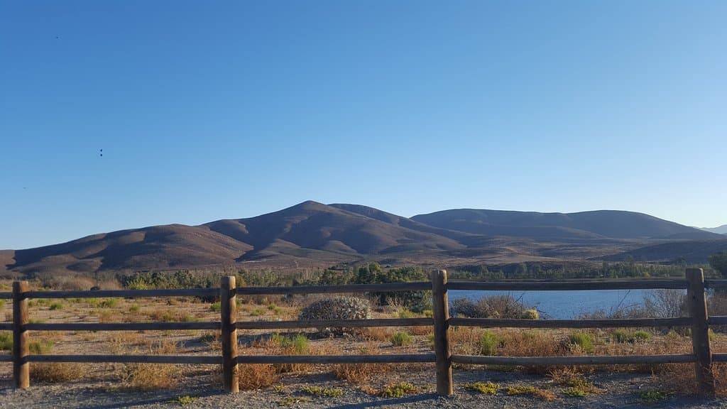 Sunrise, midday and rainy day photos of park overlooking lake