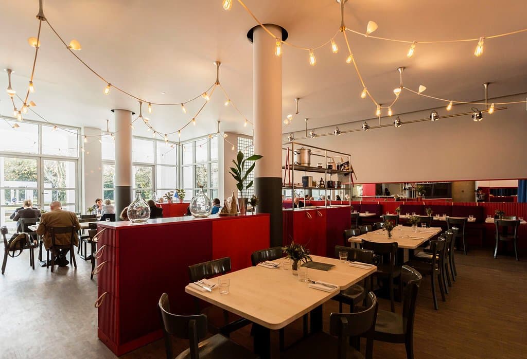 Dining Room in the Afternoon with a view out through the wintergarden in the Park.