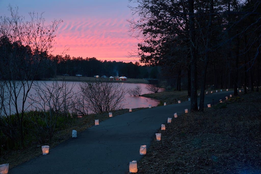 Lighted paths during the Lanterns! Festival as the sun sets over Swan Lake.