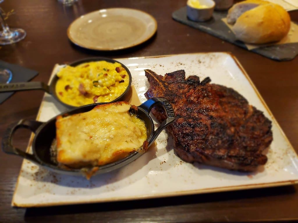 Perfectly cooked rib eye, corn and poblano au gratin potatoes.