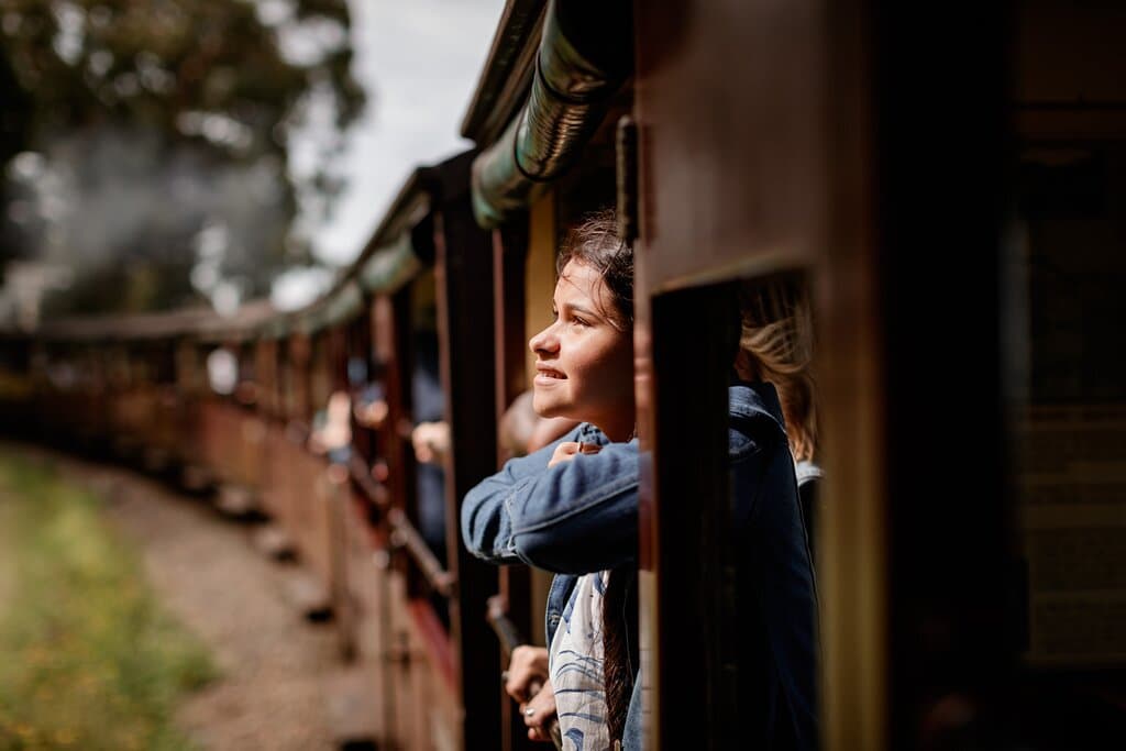 Teenage girl enjoying their trip onboard Puffing Billy Railway