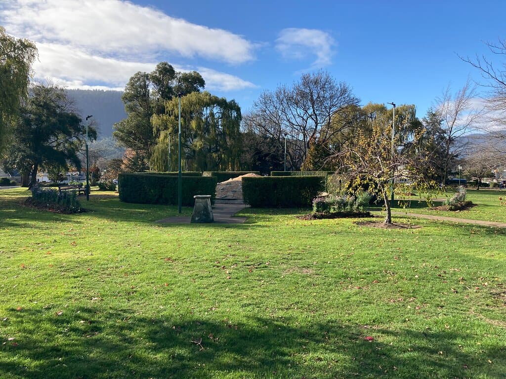 Fountain in the middle surrounded by shrubs
