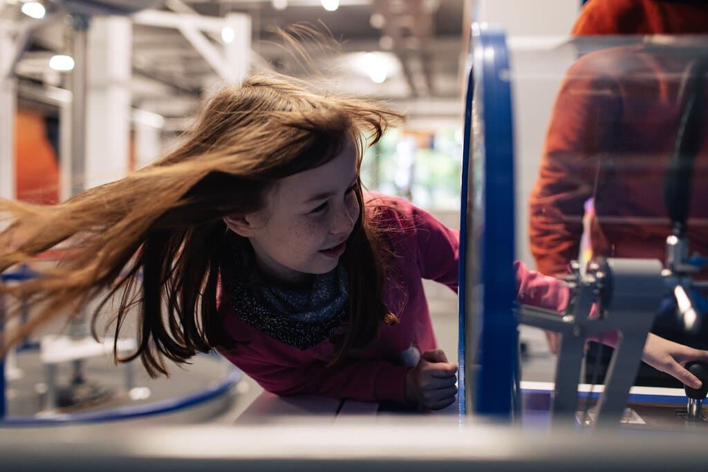 Girl looking at wind turbine exhibit