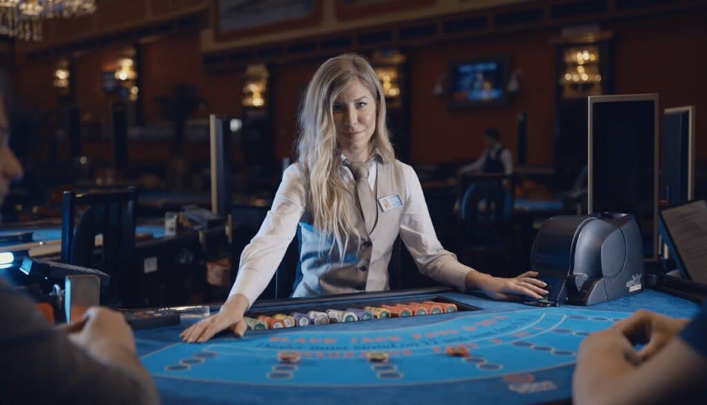 A beautiful croupier dealing at Black Jack table.