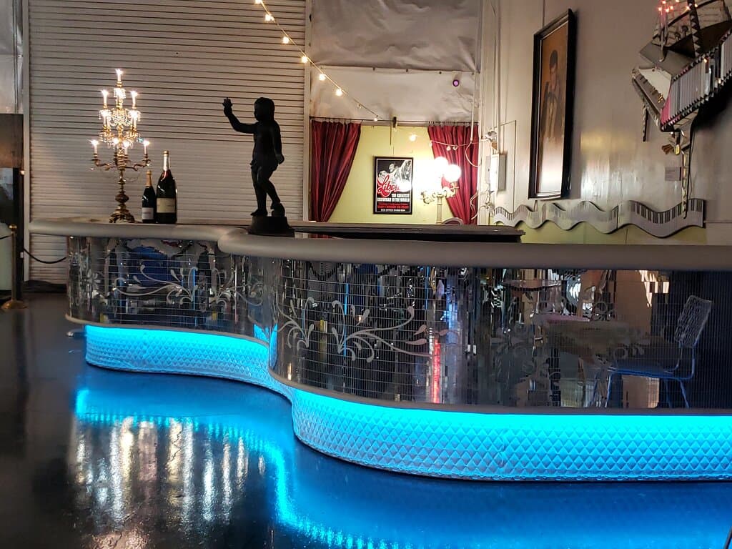 The historic Liberace Piano Bar was preserved by the Liberace Foundation when the entertainer's restaurant was demolished in 2024. This spectacularly restored 30-ft long artifact is now the catering bar for your next event at Liberace Garage!